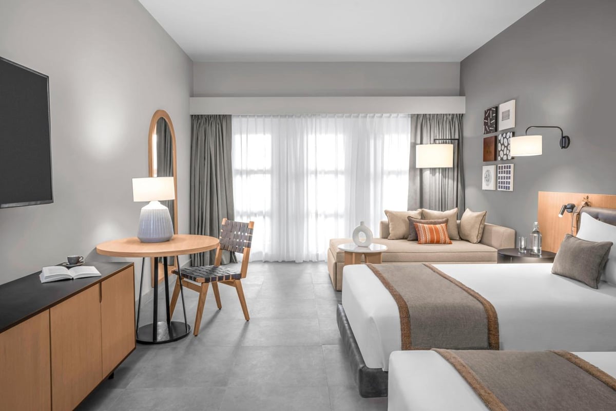 Steigenberger Golf Resort El Gouna guest room with two beds and sheer curtains.
