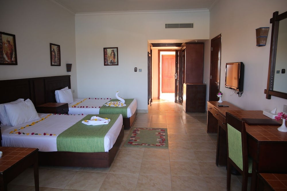 Laguna Beach Marsa Resort twin bedroom with twin beds and an open doorway.