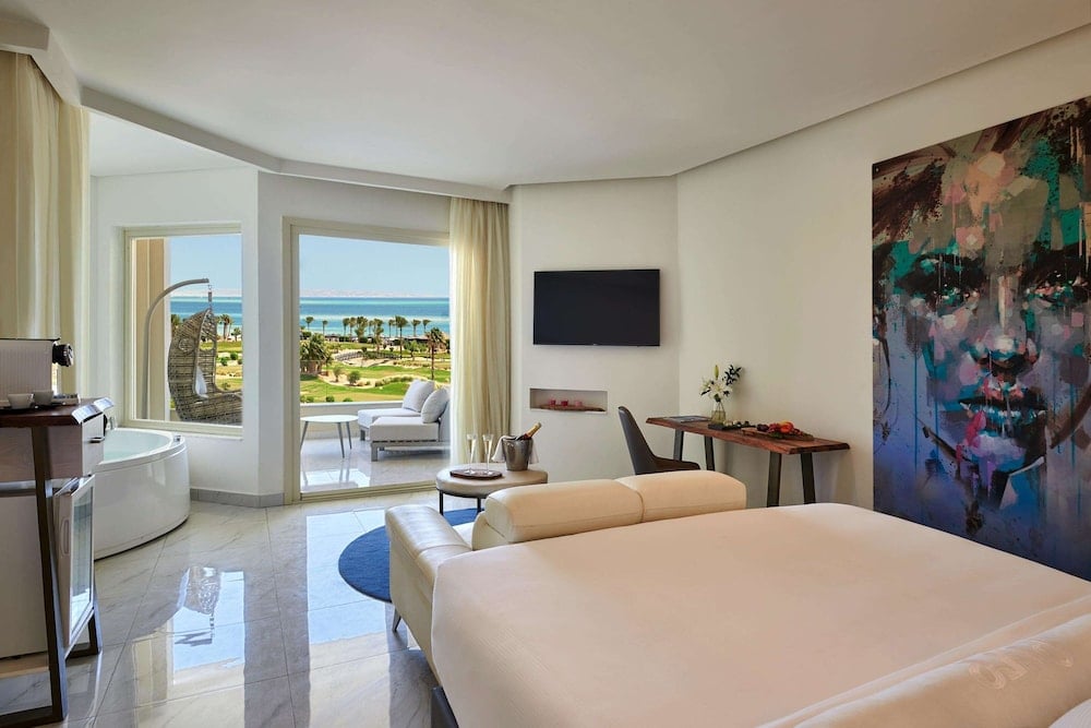 Steigenberger Pure Lifestyle (Adults Only) bedroom with a large bed and a sea view.