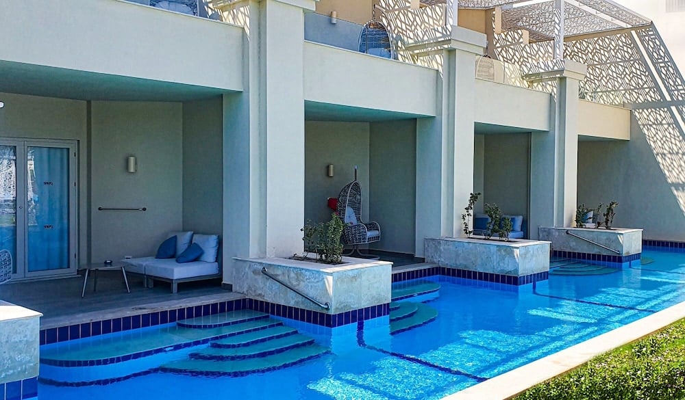 Steigenberger Pure Lifestyle (Adults Only) pool terrace with stepped entry and covered seating.