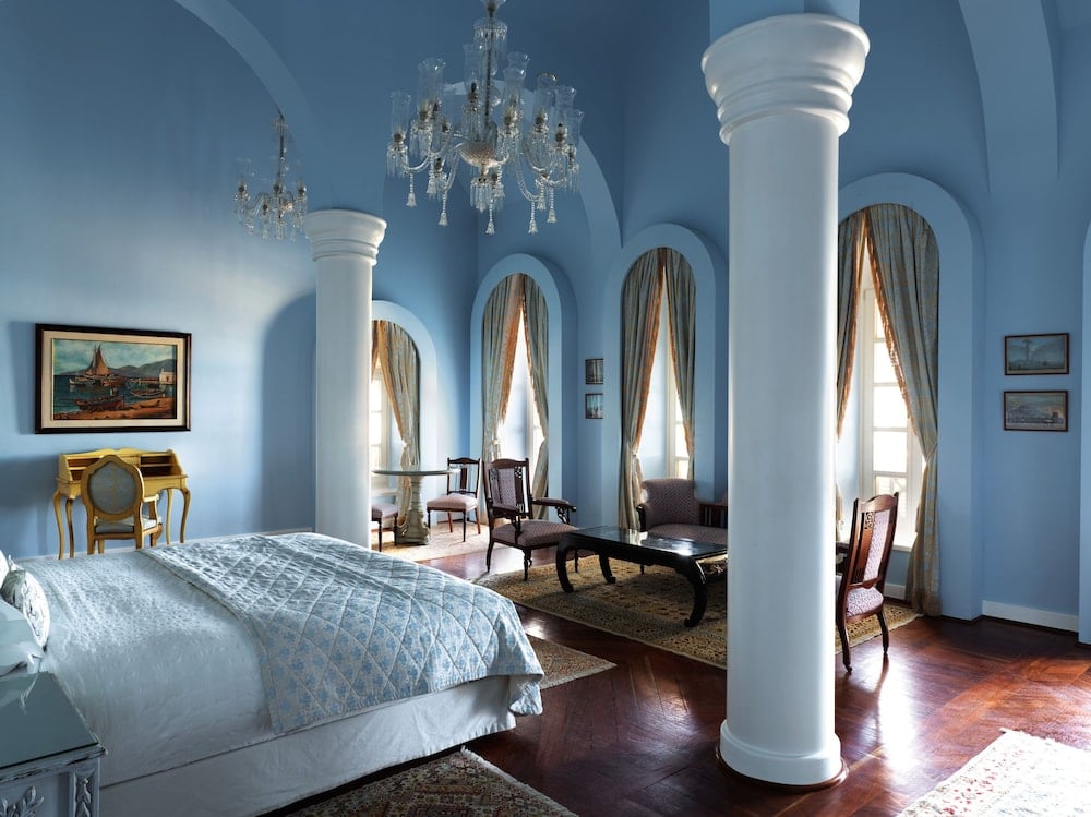 La Maison Bleue El Gouna bedroom with white columns and arched windows.