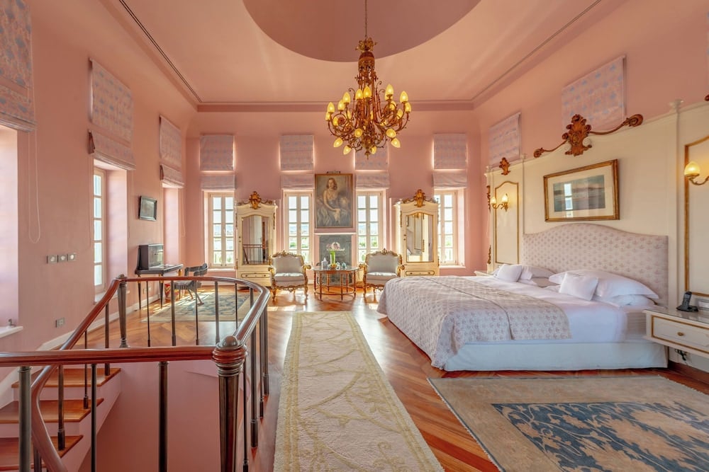 La Maison Bleue El Gouna bedroom with a large bed and chandelier.