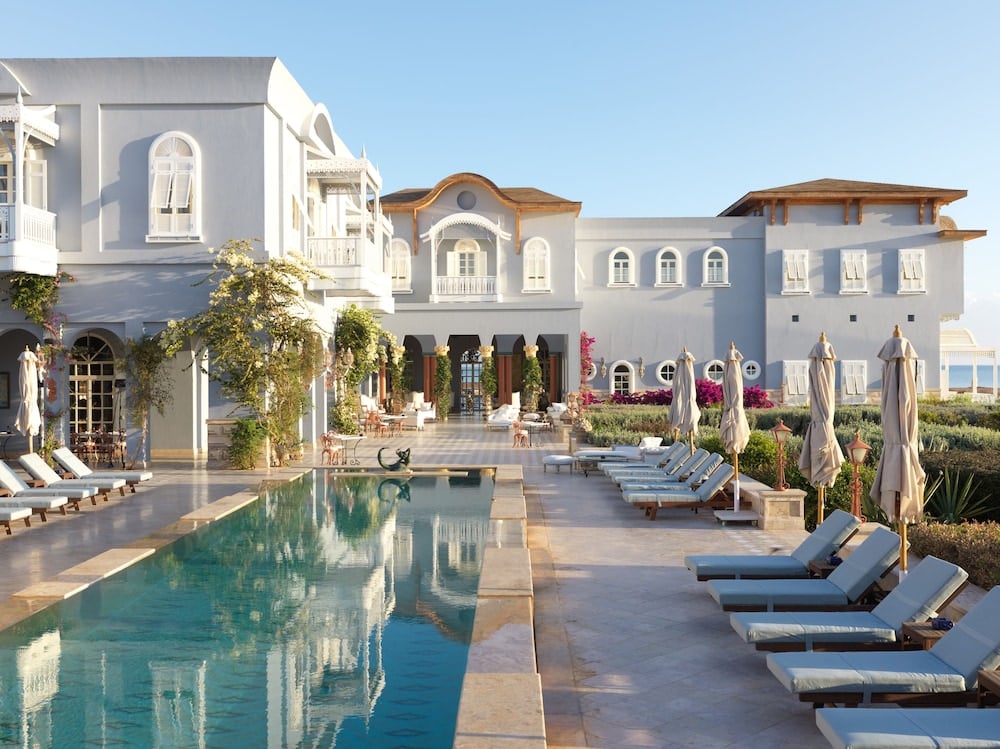La Maison Bleue El Gouna pool terrace with a long pool and rows of loungers.