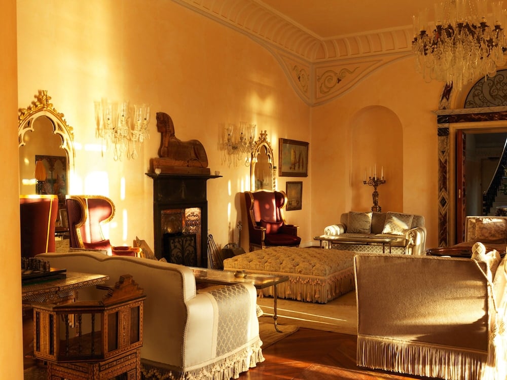 La Maison Bleue El Gouna lounge with a fireplace and upholstered seating.