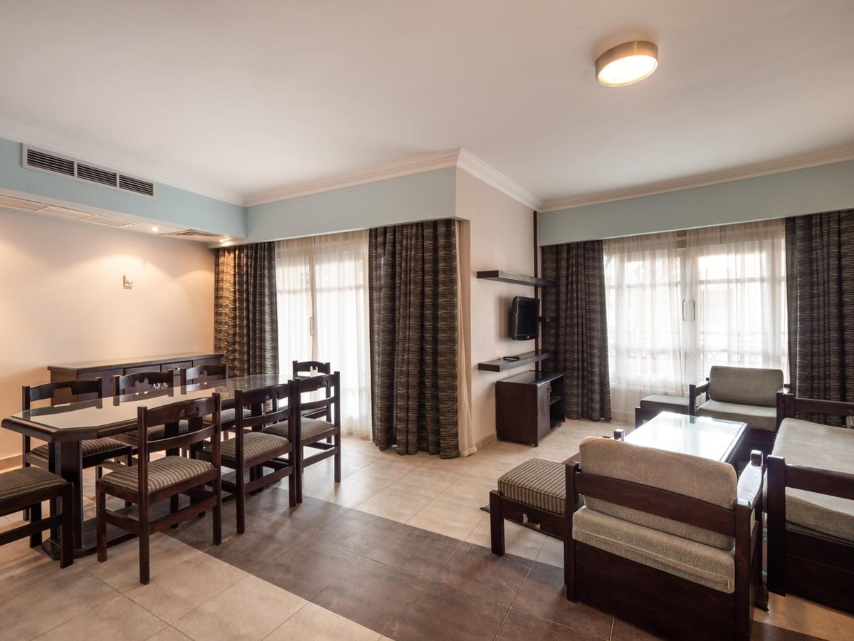 Sunny Days Mirette Family Resort living and dining room with a dining table and lounge seating.