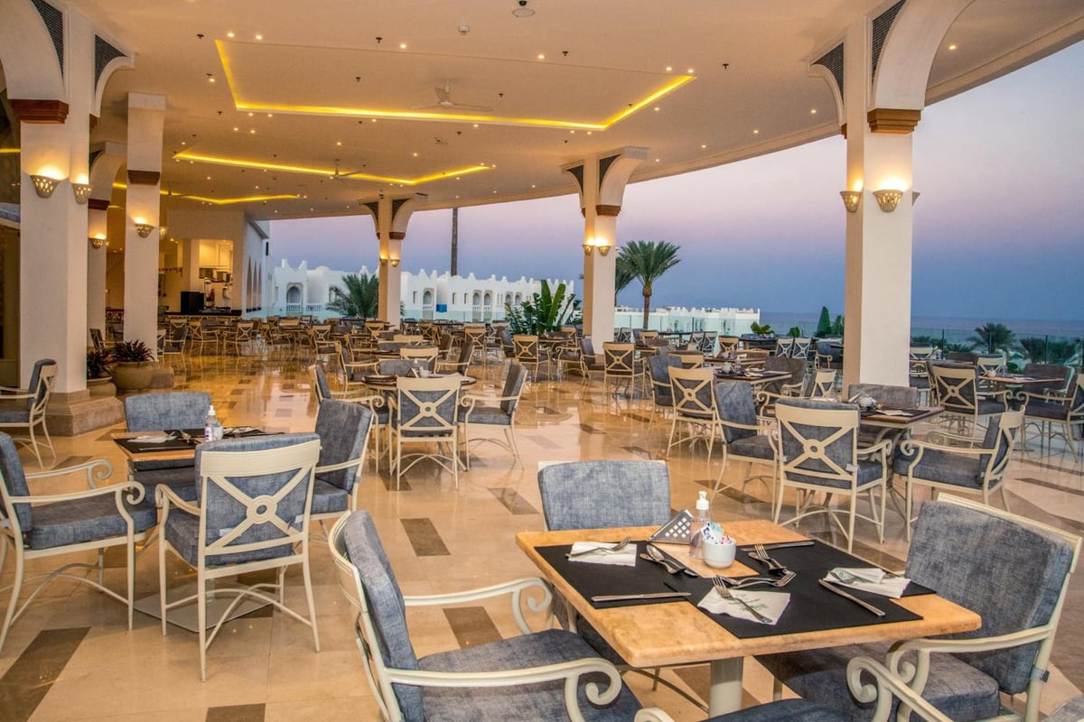 Sunrise Diamond Beach Resort Grand Select restaurant terrace with arched columns and a sea view.