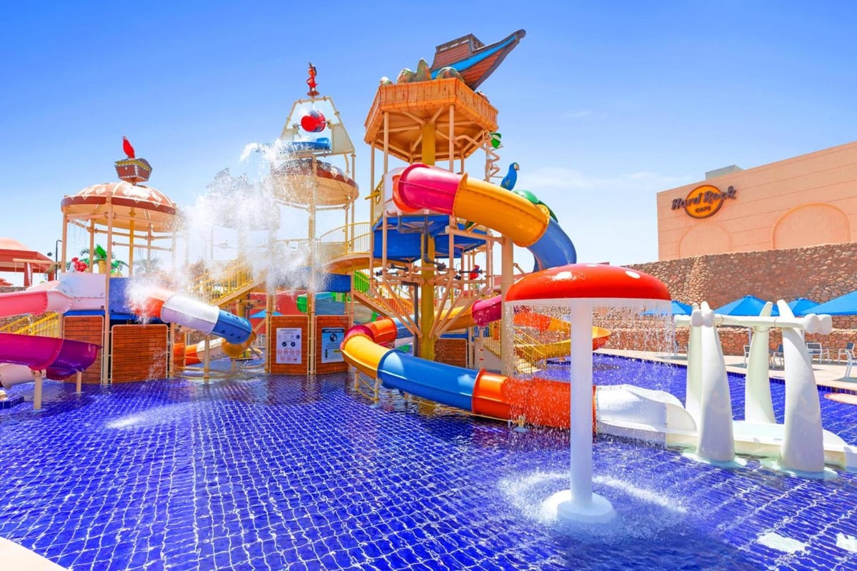 Pickalbatros Laguna Vista Aqua Park splash pool with colorful water slides and spraying fountains.