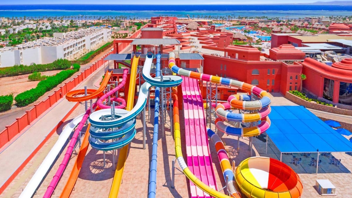 Pickalbatros Laguna Vista Aqua Park water slide park with colorful slides and red buildings.