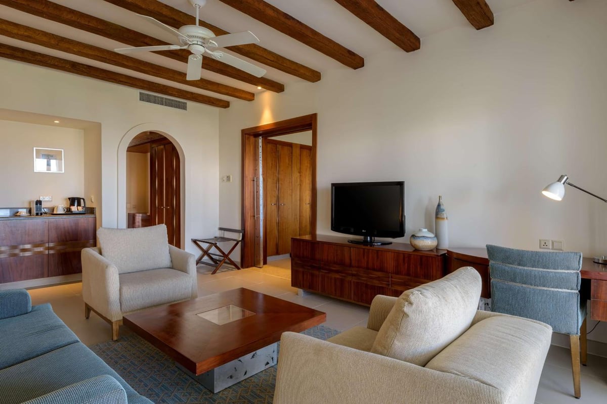 Hilton Marsa Alam Nubian Resort living area with wooden ceiling beams and upholstered seating.