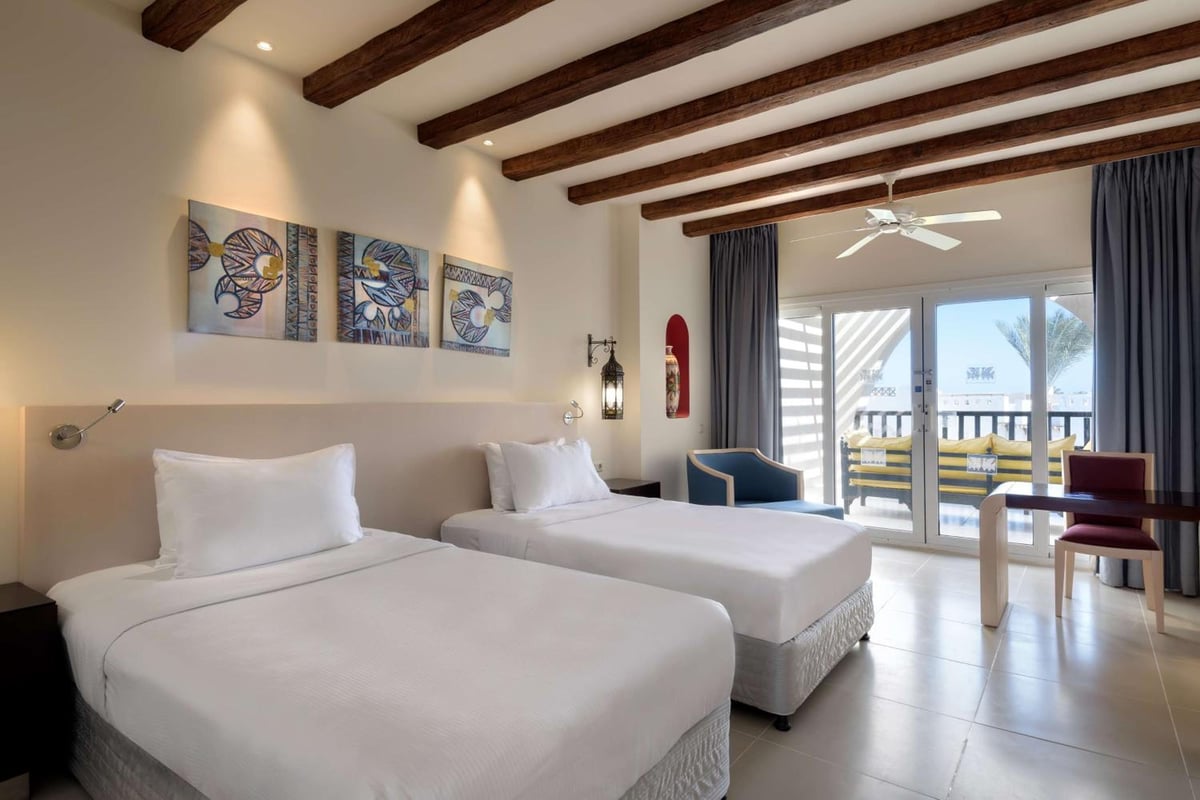 Hilton Marsa Alam Nubian Resort twin guest room with two beds and a balcony.