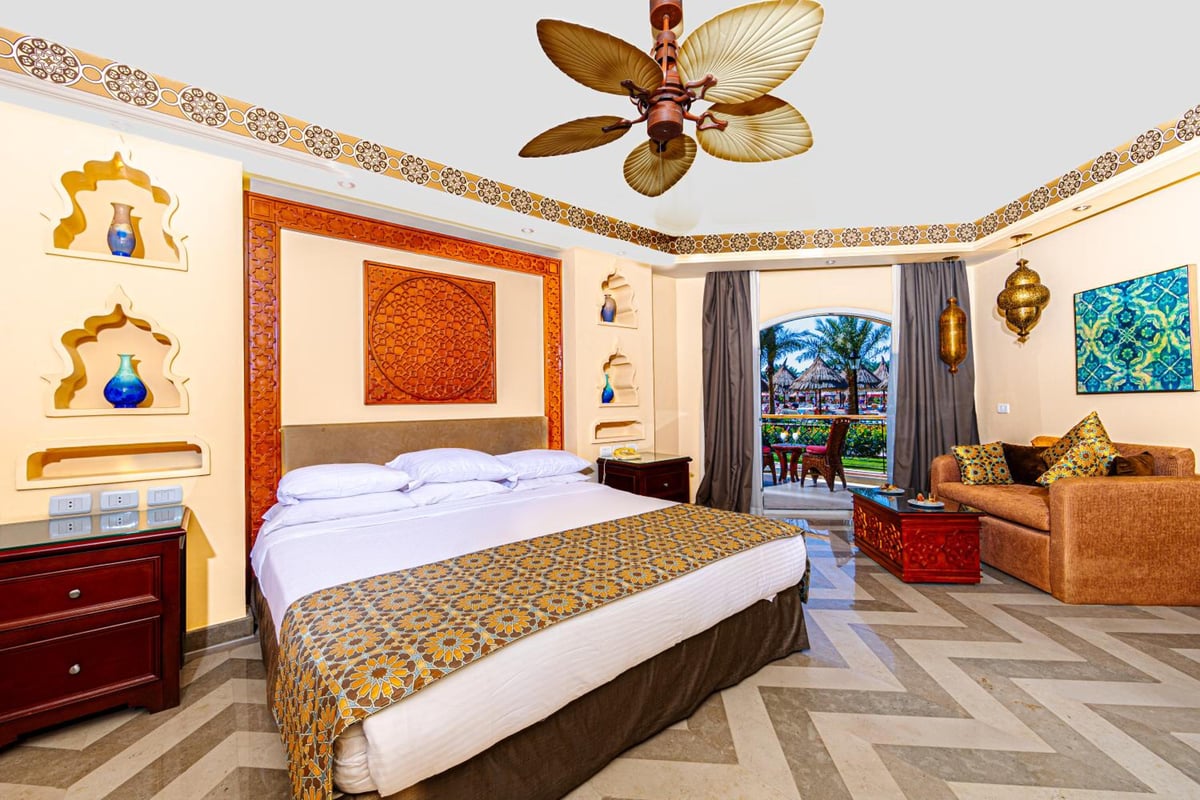 Siva Grand Beach guest room with a large bed and a sitting area.
