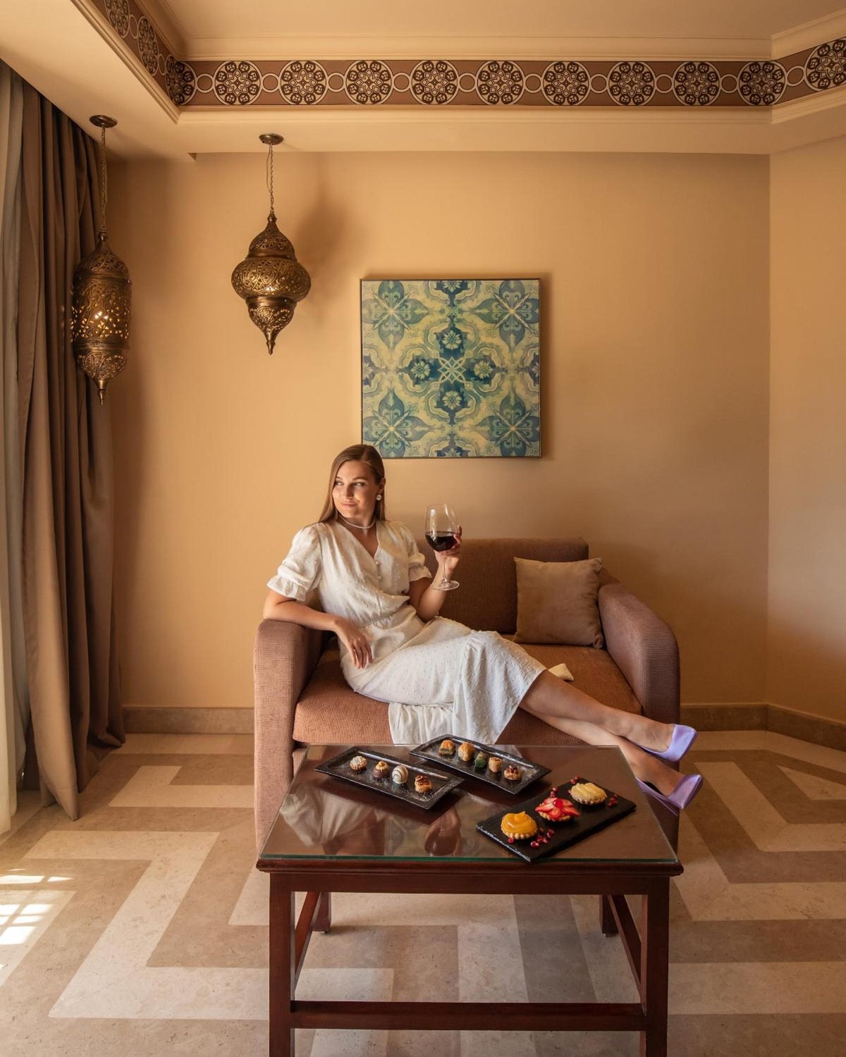 Siva Grand Beach sitting area with a sofa and geometric floor.