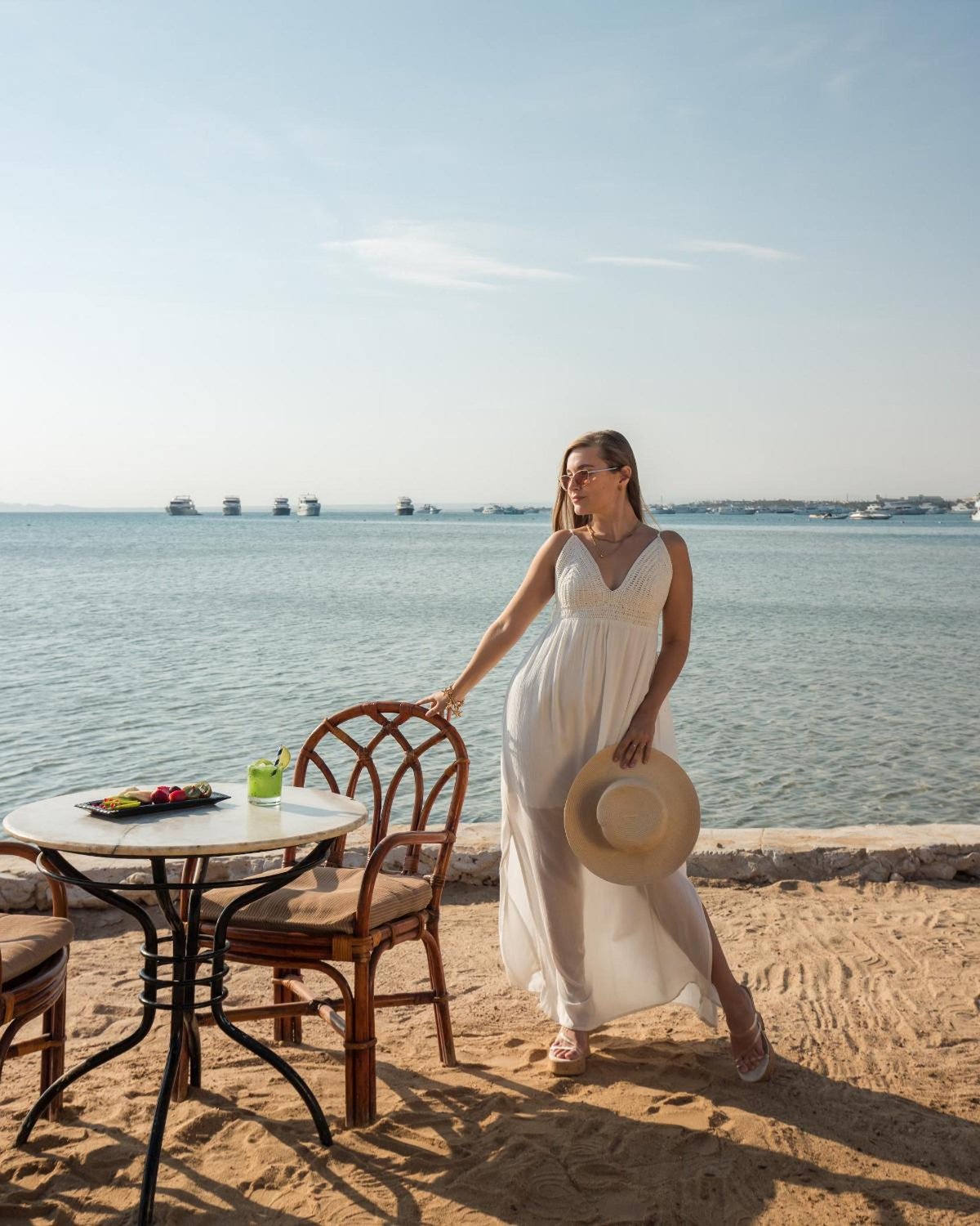 Siva Grand Beach beach seating area with wooden chairs and a sea view.