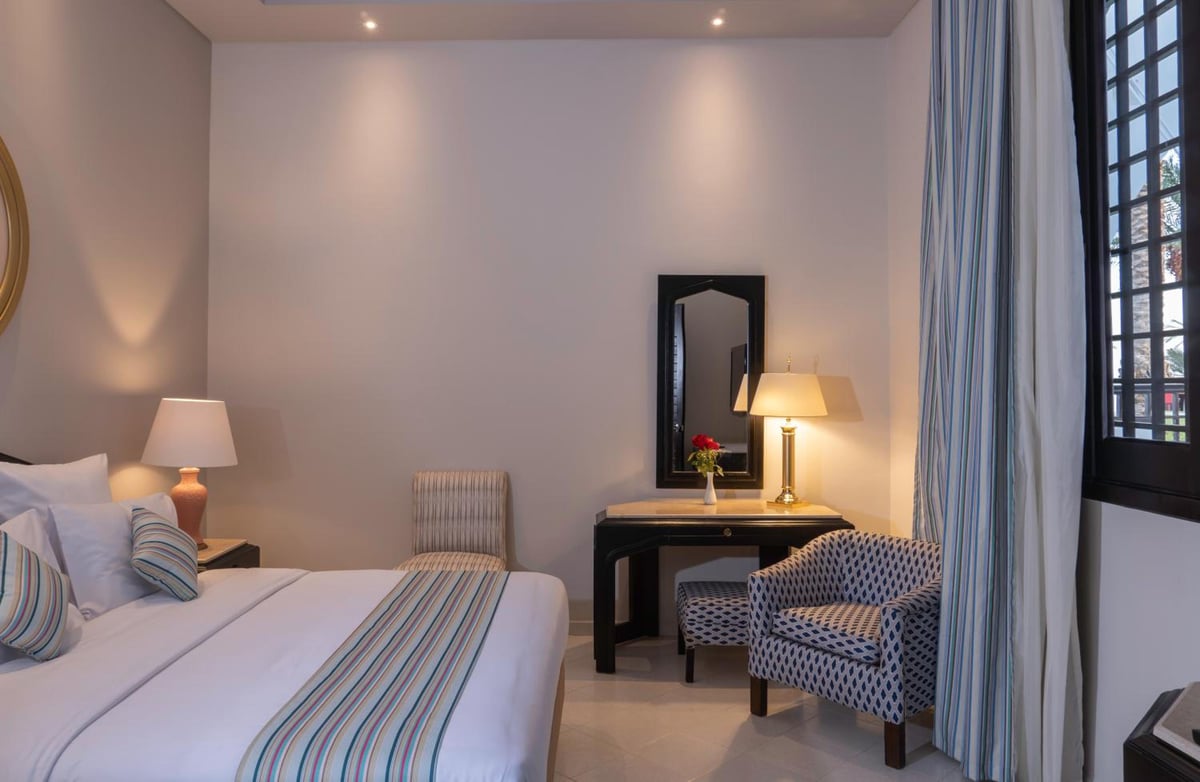 Safir Dahab Resort guest room with a bed and writing desk.