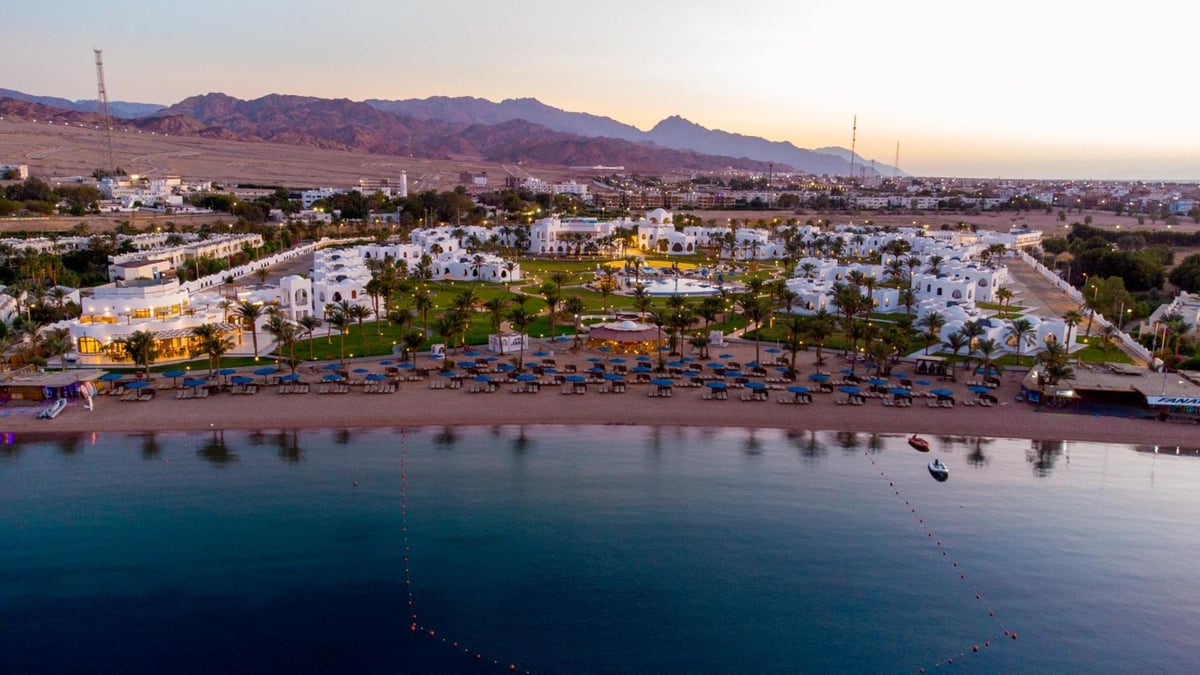 Safir Dahab Resort beachfront with a sandy shore and calm water.
