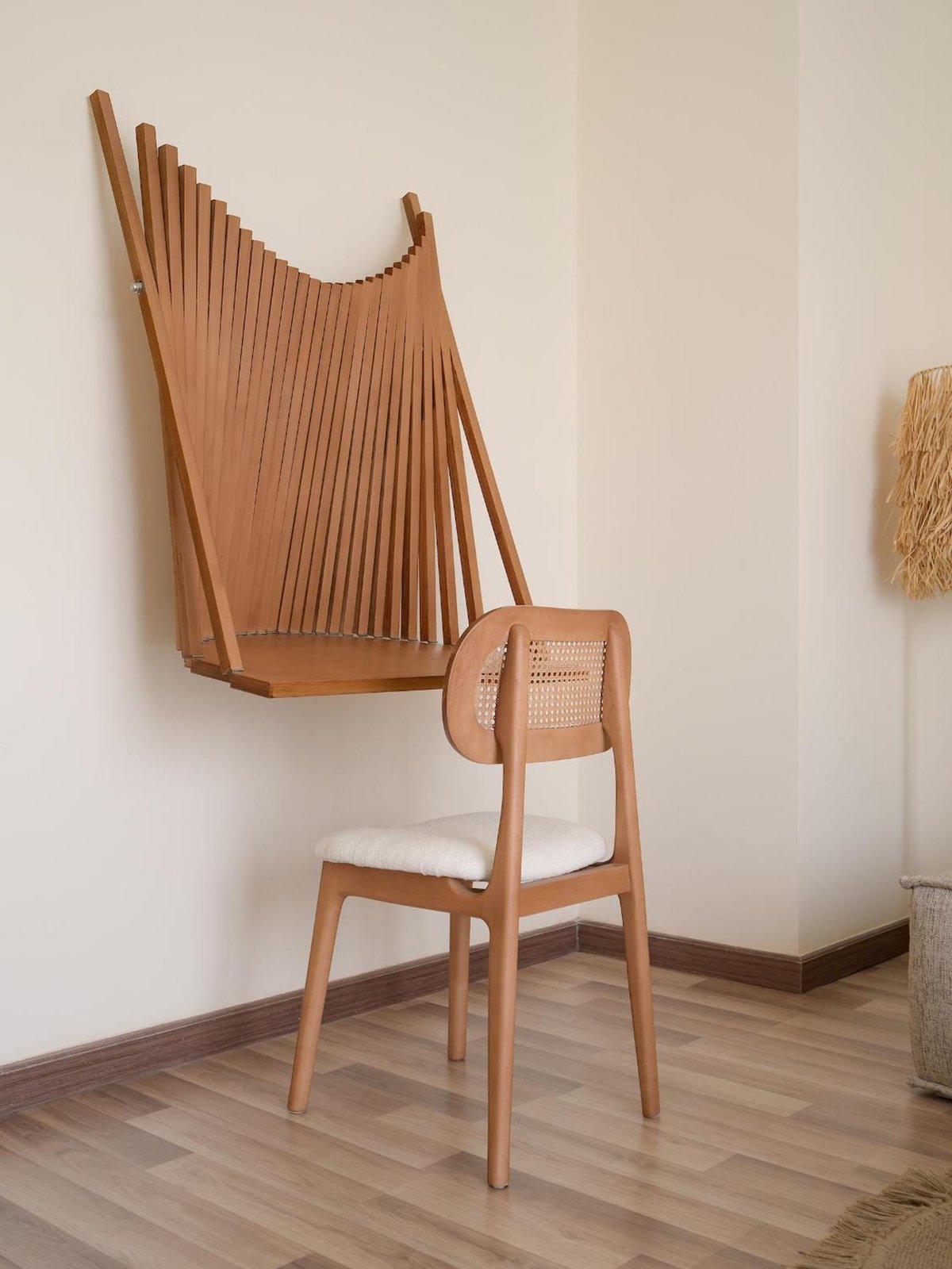 The Zen Wellness Resort Aswan seating area with a woven-back chair and slatted wooden wall piece.