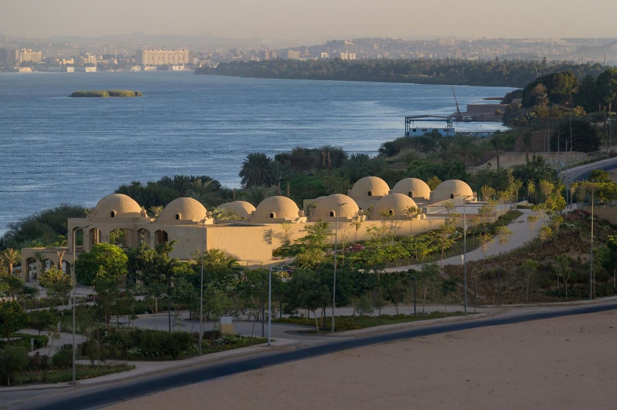 The Zen Wellness Resort Aswan riverfront exterior with domed roofs and landscaped grounds.