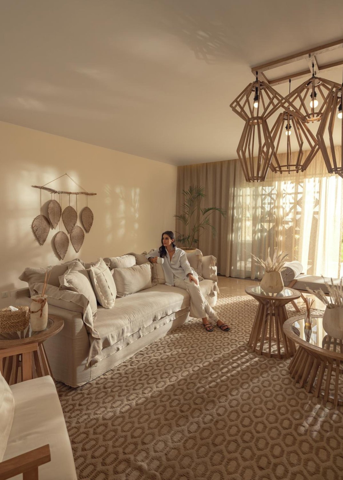 The Zen Wellness Resort Aswan lounge with beige sofas and woven pendant lights.