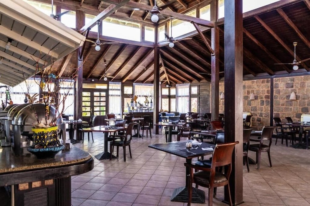 Abu Dabbab Lodge restaurant with an exposed timber roof and stone walls.